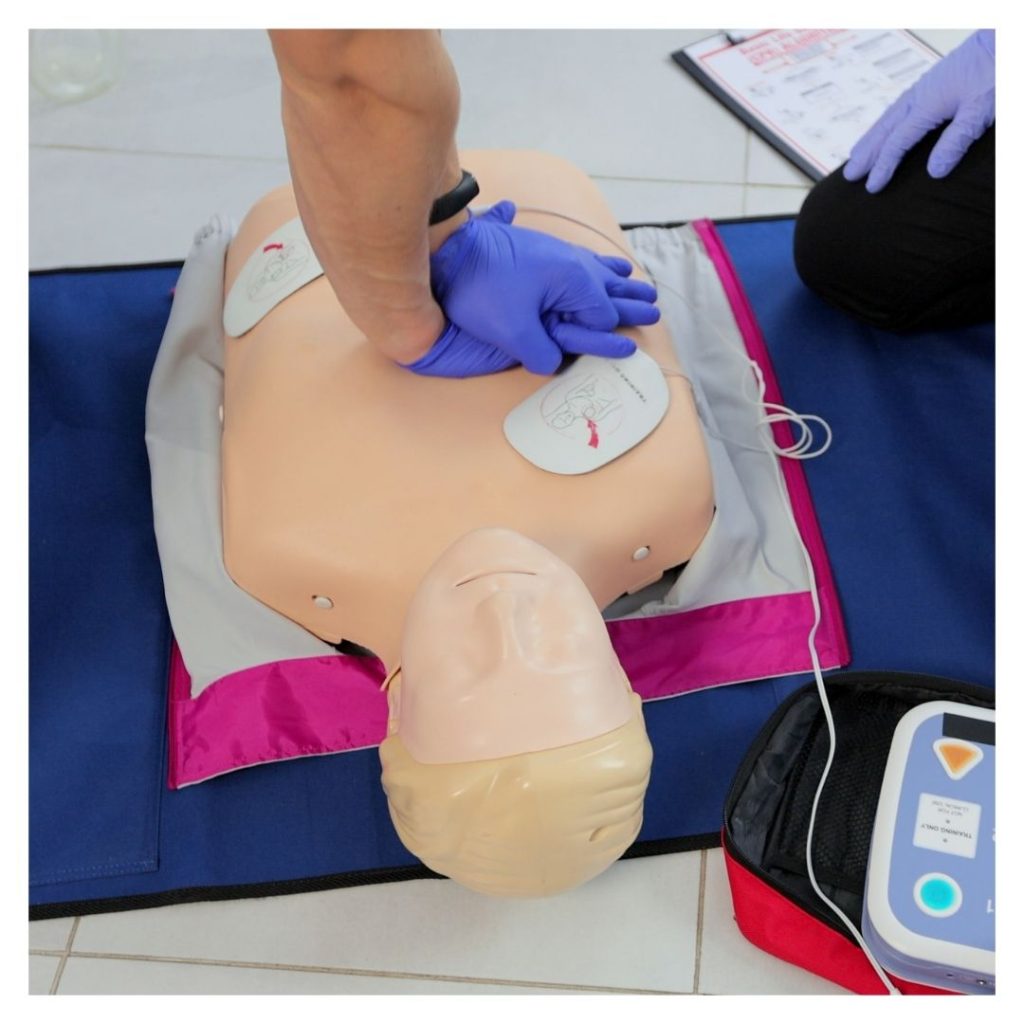 person doing CPR on a dummy