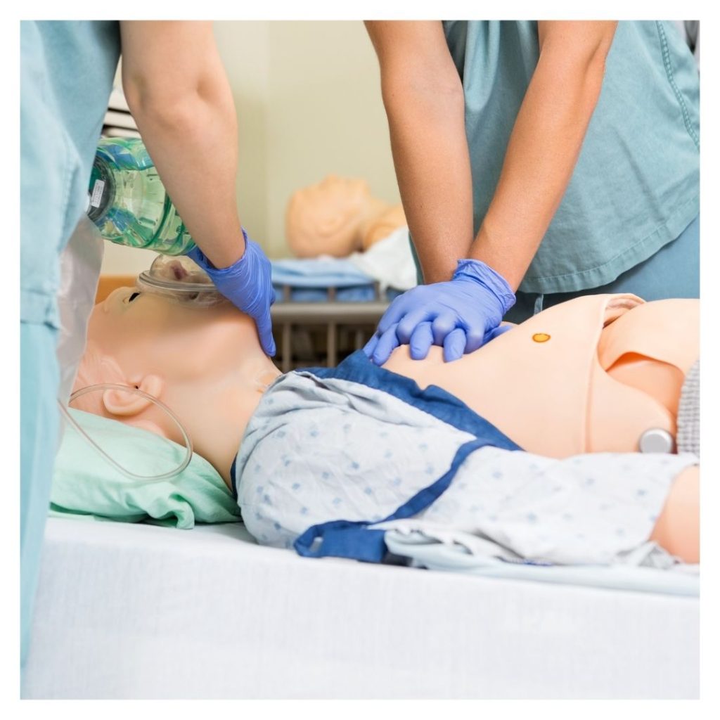 medical professionals performing CPR on a dummy