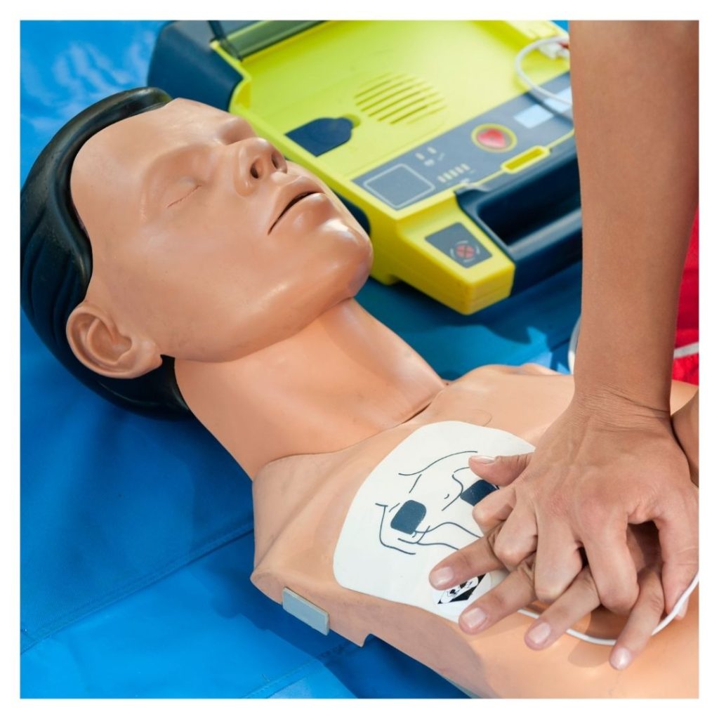 person giving dummy CPR