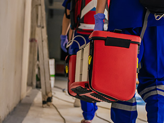 EMT carrying a large AED pack