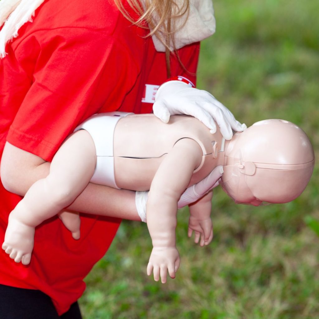 someone practicing first aid on a dummy 